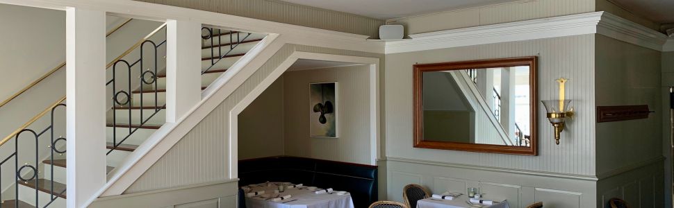 Room full of tables covered in white table cloth