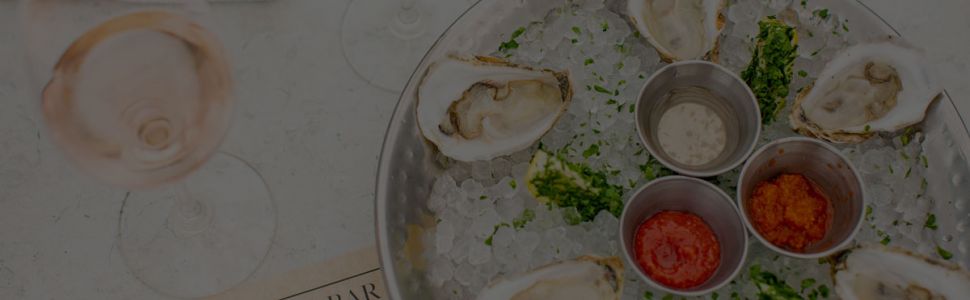 Oyster platter next to a glass of white wine